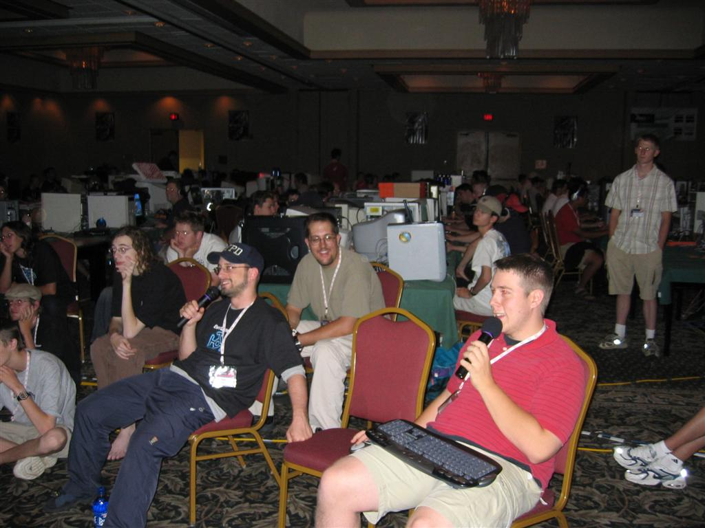 stickgod shoutcasting with a microphone on the floor of a LAN event