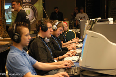 Team Wat¿ wearing headsets and competing side by side on Halo computers